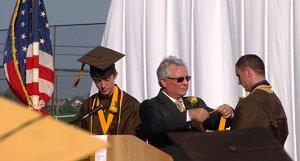 Principal Shirey commends Corey Clifford - Salutatorian (left) and Douglas Adams - Valedictorian (right).