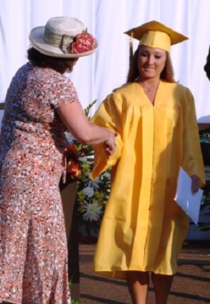 School Board President Debbie Beale congratulates Taylor Livingston.
